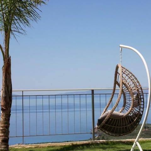 Unwind in the swing seat with a good book and the sea view