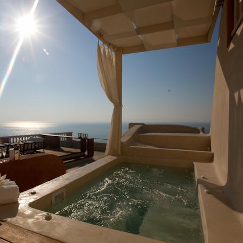 Soak in the bubbling Jacuzzi with a panoramic sea view