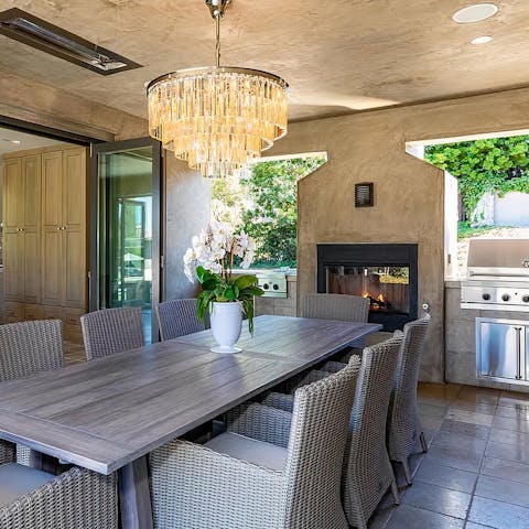 Keep the dinner party flowing beside the outdoor fireplace 