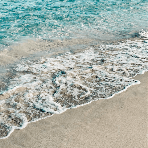 Sink your toes in the sand at Talamanca Beach, less than a ten-minute walk away