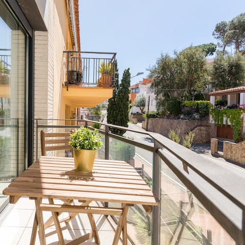 Admire the Mediterranean street view from the sun-kissed balcony at home