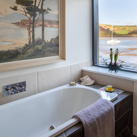 Enjoy a relaxing soak in the en-suite bathtub with views over the creek