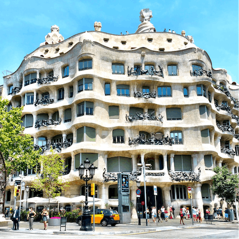 Visit Gaudí's Casa Milà, a seven-minute walk from your building