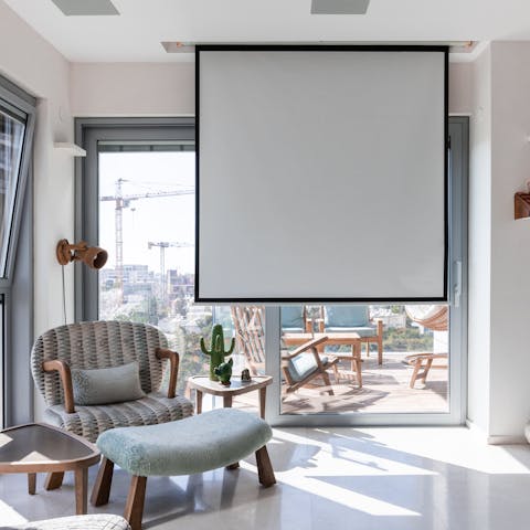 Get a film going on the projector screen for a movie night in