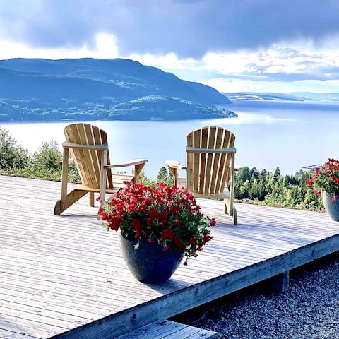 Relax on the decking to drink in the stunning views of Lake Mjøsa