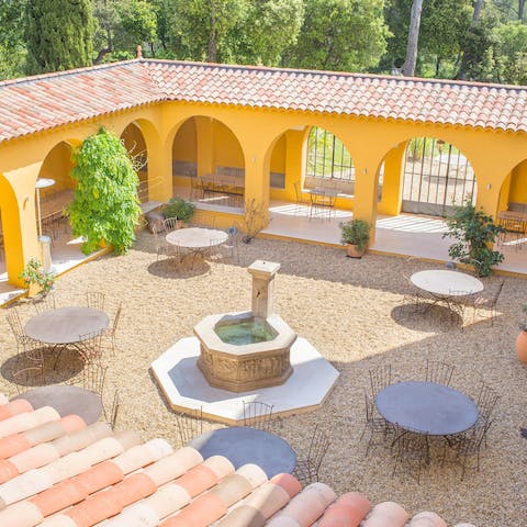 Dine around the fountain on the home's pretty courtyard 
