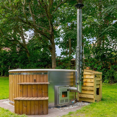 Enjoy a long soak in the home's wood-fired hot tub