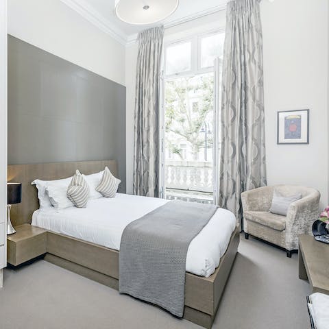 Wake up to leafy Kensington views from the bedroom's floor-to-ceiling windows
