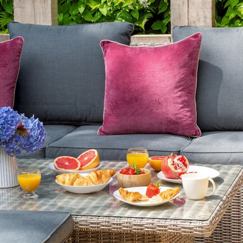 Tuck into a delicious breakfast of pastries and fresh fruit on the secluded decking area