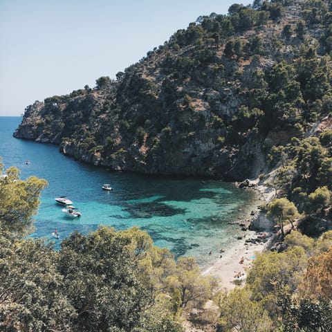 Swim and snorkel in the crystal-clear waters of nearby Cala Blanca