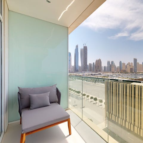 Sit back and admire dreamy Dubai views from your private glass fronted balcony