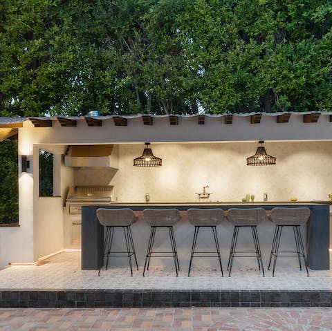 Whip up a barbecue in the outside kitchen – complete with bar-style seating