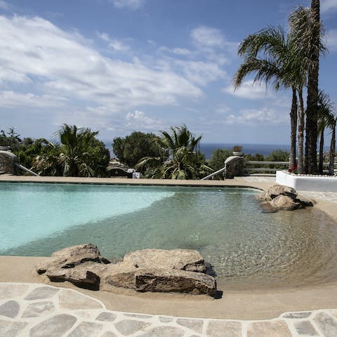 Slip into the crystalline swimming pool like your own beach