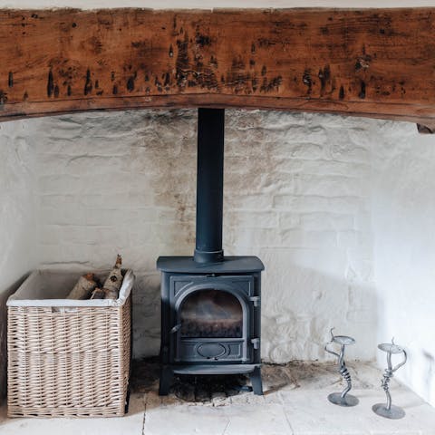 Get cosy around the flickering log fire set in a glorious traditional inglenook fireplace 