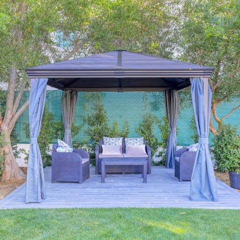 Sneak off for a moment to yourself in the shady gazebo