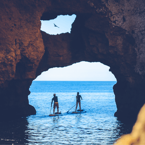 Explore the dramatic coastline by paddleboard or boat
