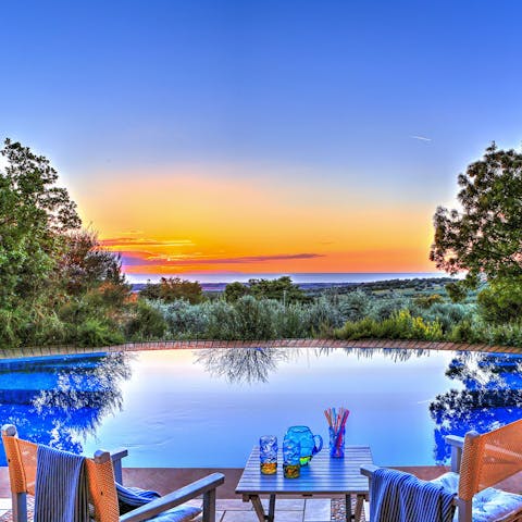 Watch the sunset from the poolside as you sip a glass of fizz