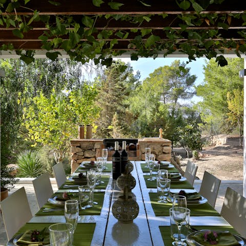 Enjoy lunch under the pergola's vines