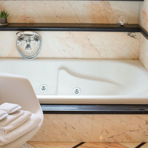 Indulge in a pamper session in the jacuzzi bathtub 