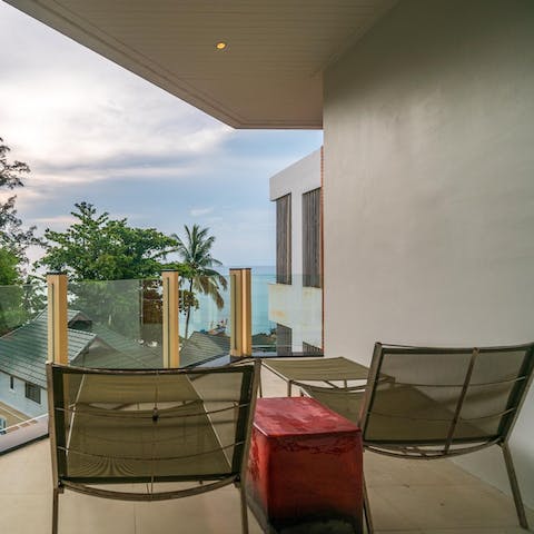 Relax on the private balcony with an Andaman Sea view