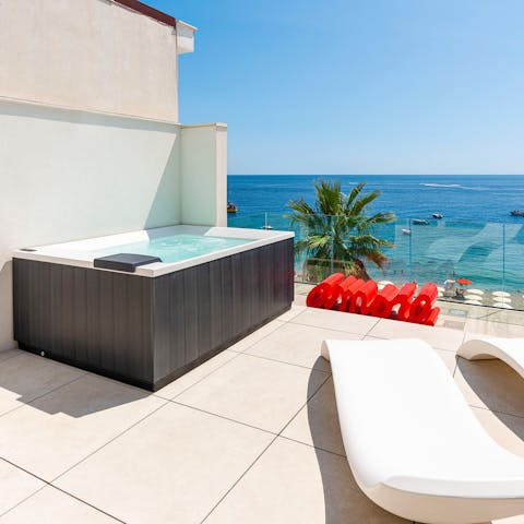 Soak up the sun from the Jacuzzi on the terrace
