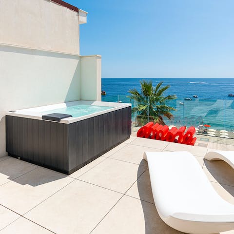 Soak up the sun from the Jacuzzi on the terrace