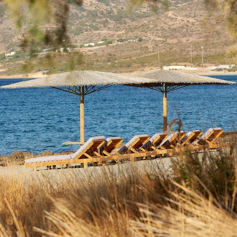 Soak up the sunshine on the communal loungers on the beach