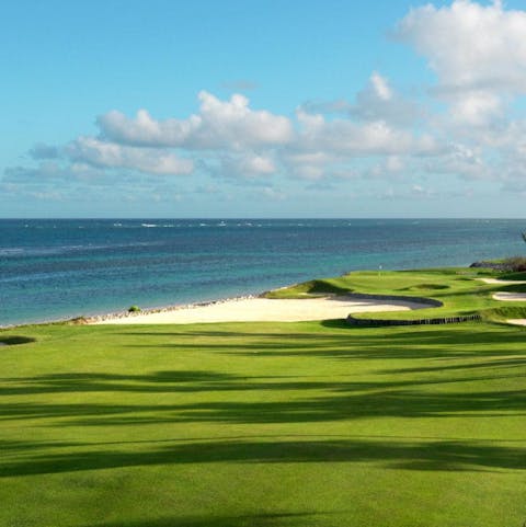 Tee off at the seaside golf course, part of your exclusive resort