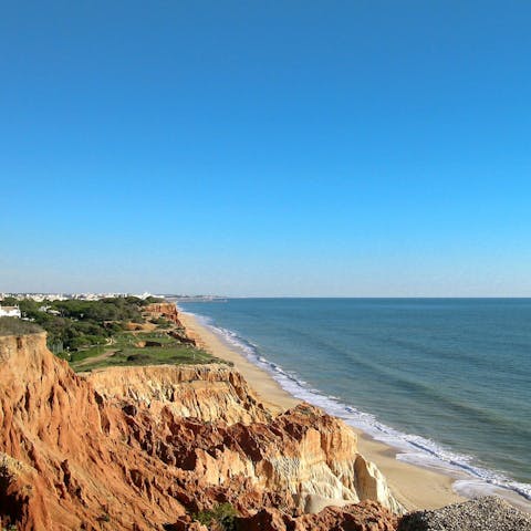 Celebrate the sun from the golden sand of Praia de Vilamoura, a drive away