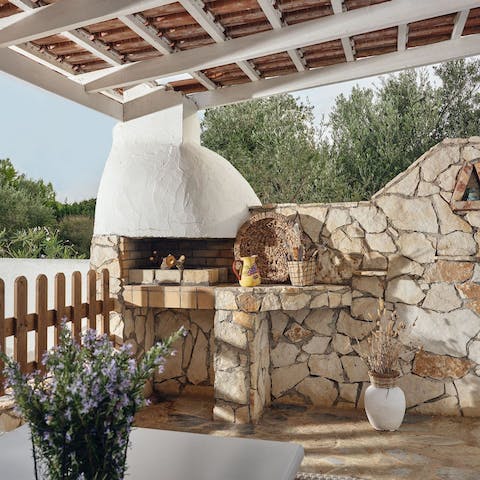 Tuck into a meal cooked on the rustic barbeque under the sun