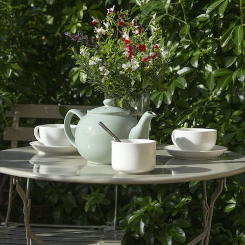 Enjoy a cup of tea in the pretty garden, soaking up the sun