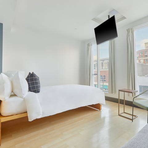Wake up to floor-to-ceiling Queen West views from the comfortable bed