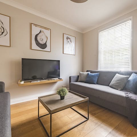 Unwind with a glass of wine in the stylish living room