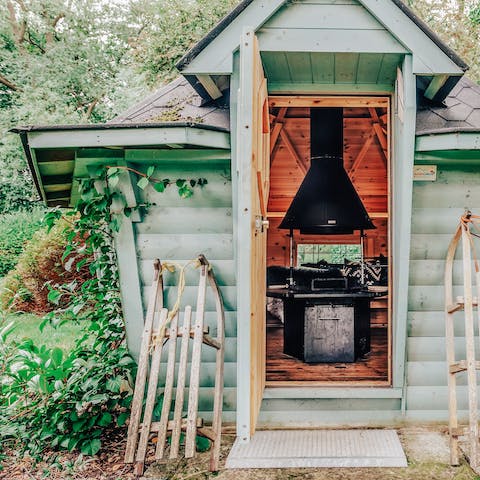 Hide out in the cabin in the woods, complete with an open firepit