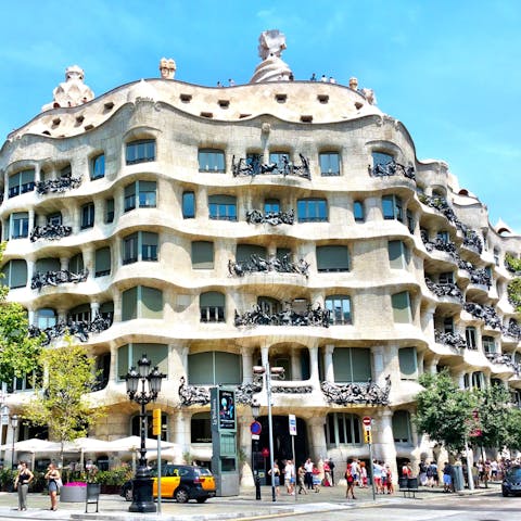 Visit Casa Milà, the private residence designed by Gaudí, just a twelve-minute walk away