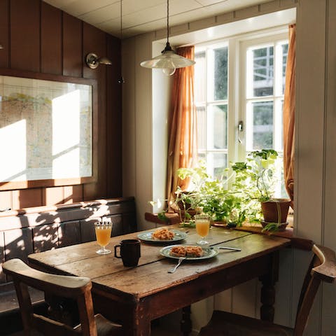 Gather together for sunny breakfasts at the kitchen's rustic dining table
