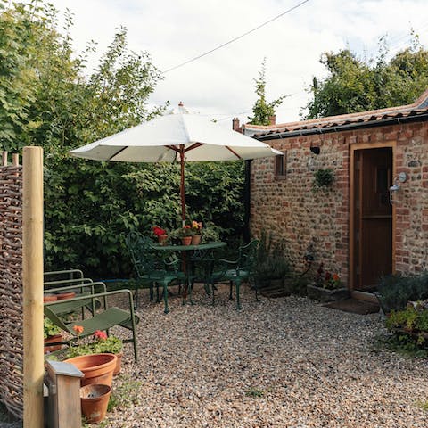 Sit down to an alfresco meal in the private garden