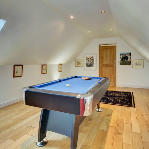 Play a game of pool on the shared table