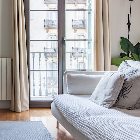 Rest your feet on the sofa after a busy day and admire the apartment's traditional Catalan features