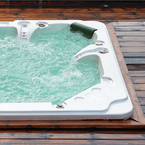 Sit back and relax with a glass of something bubbly in hand in the outdoor hot tub