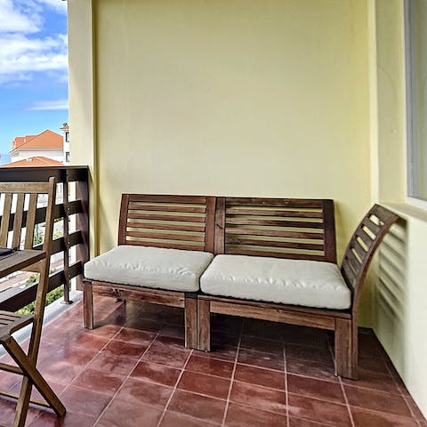 Relax on the outdoor seat, catching up on your current read while enjoying the peaceful sea view