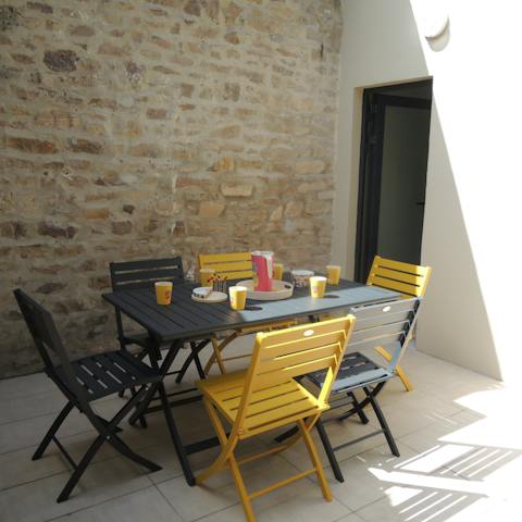 Savour a meal together in the shaded courtyard-style patio