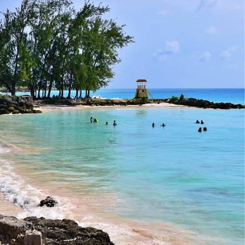 Drive down to the idyllic Sandy Lane Beach for a day by the turquoise sea