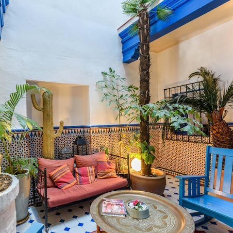 Take a seat on the peaceful indoor patio, surrounded by plants