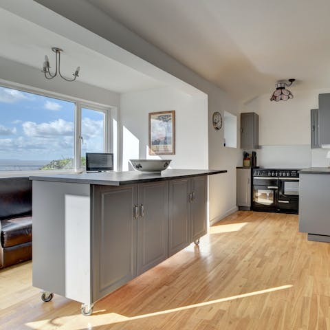 Chop up some vegetables at the kitchen island with views of the sea