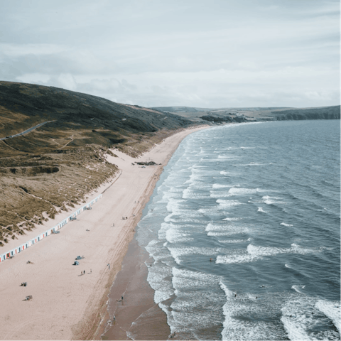 Spend sandy days at Woolacombe Beach, a surfer's paradise  – just an eight-minute drive away