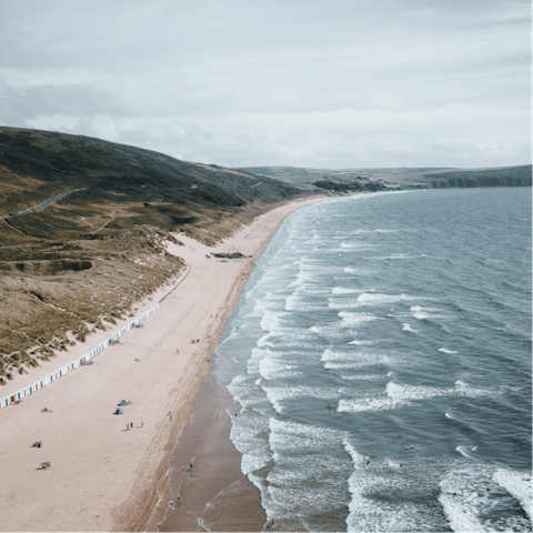 Spend sandy days at Woolacombe Beach, a surfer's paradise – just an eight-minute drive away
