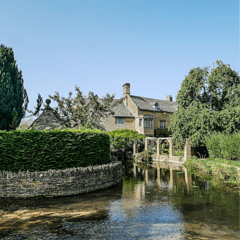 Drive thirty-five minutes into the Cotswolds Area of Outstanding Natural Beauty and reach the charming village of Bourton-on-the-Water