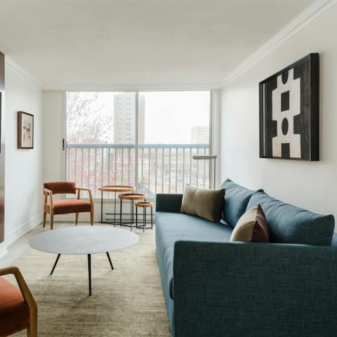 Relax in the bright living room with its floor-to-ceiling windows after a busy day of sightseeing