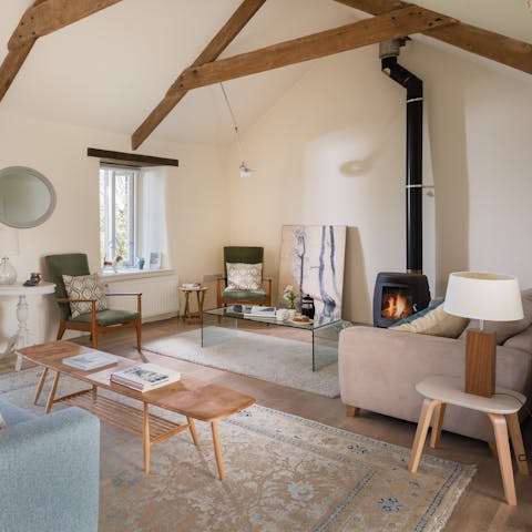 Stay warm and cosy by the fire in the serene living space